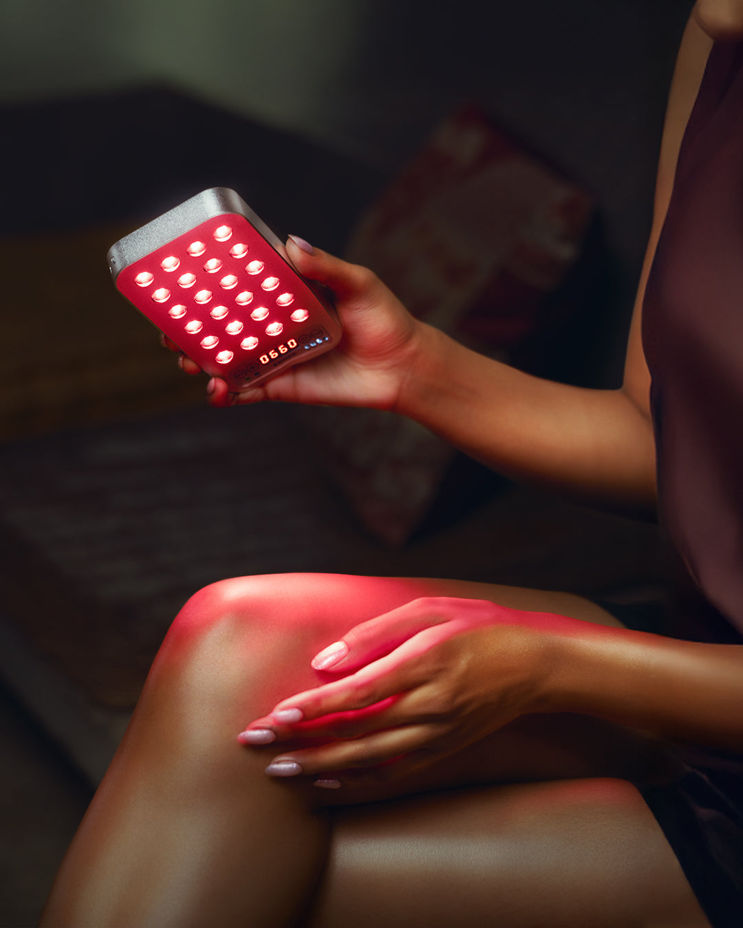HealLite Nano red light therapy device in use on hand dark studio lifestyle Biotastic India